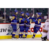 Saskatoon Blades gather after a goal